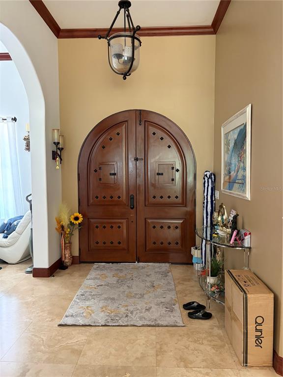 A spacious living room features white sofas, a large television, and light-colored tile flooring — 4205 CREMONA COURT, SEBRING, FL