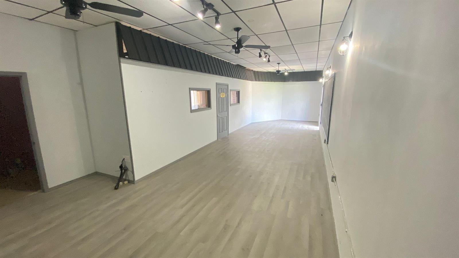 An empty commercial space with light wood-look flooring, white walls, and a drop ceiling — 4650 US Highway 27, Sebring FL 33870, SEBRING, FL