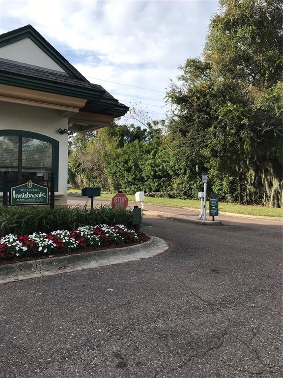 The entrance to Innisbrook Resort features a welcome sign, a stop sign, and landscaping — 36750 US HIGHWAY 19 N UNIT 2879, PALM HARBOR, FL
