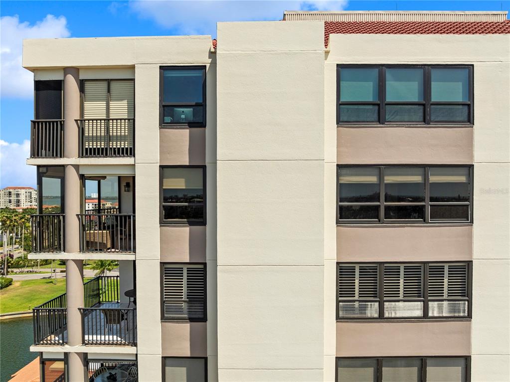 An exterior view of a multi-story apartment building featuring balconies and large windows — 6294 BAHIA DEL MAR CIRCLE UNIT 904, ST PETERSBURG, FL