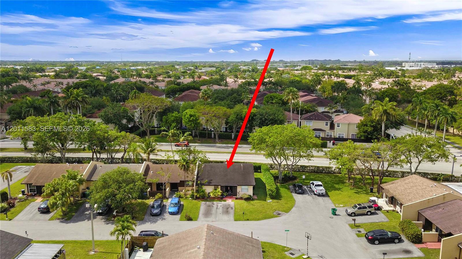 An aerial view shows a single-story residential building with a dark roof and driveway — 12316 SW 119th Ln, Miami FL 33186, MIAMI, FL