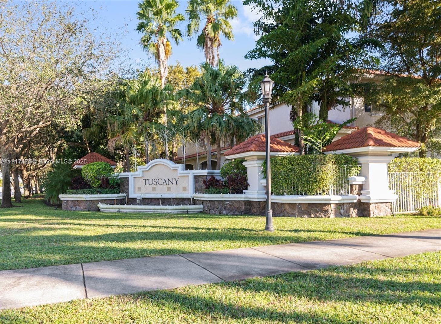 A stone monument sign labeled Tuscany sits in front of a landscaped residential complex — 8208 SW 25th Ct # 103, Miramar FL 33025, MIRAMAR, FL