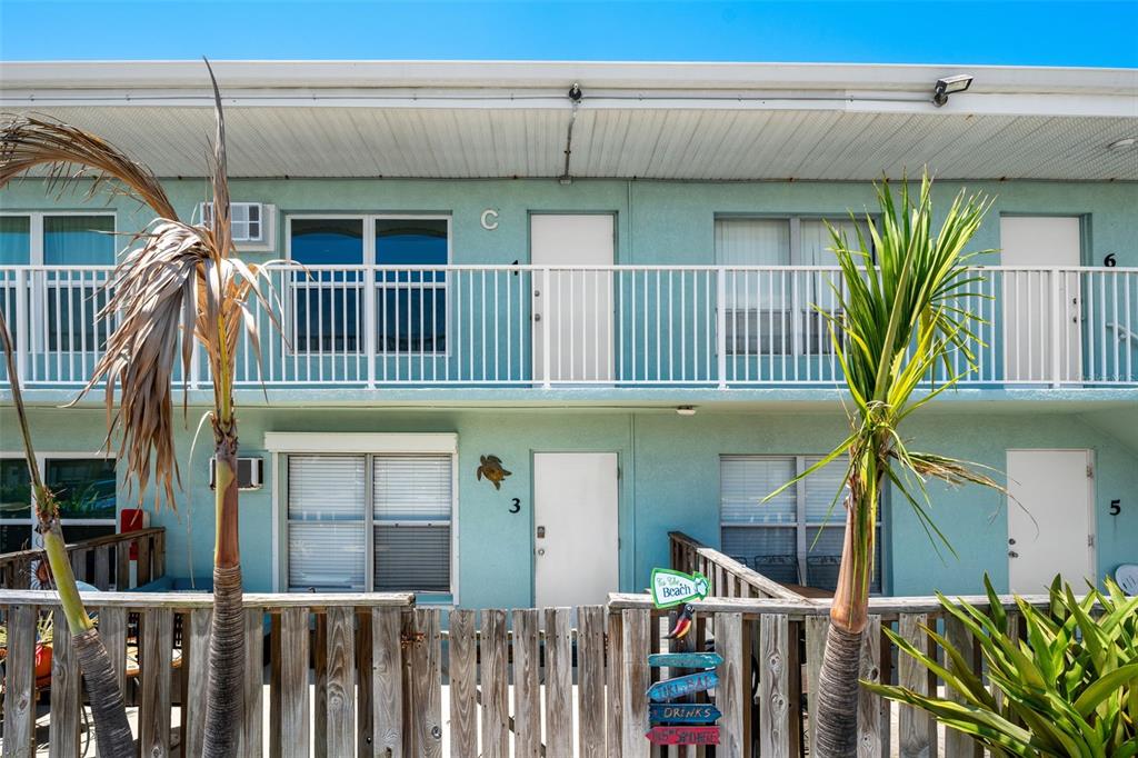 A two-story light blue motel building with white doors, railings, and a wooden fence — 420 TYLER AVENUE UNIT 4-3, CAPE CANAVERAL, FL