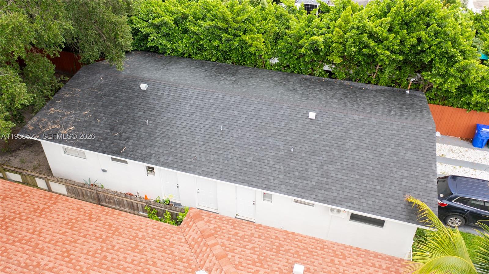 An aerial view shows the dark shingled roof of a white building with multiple doors — 1831 NW 41 st, Miami FL 33142, MIAMI, FL