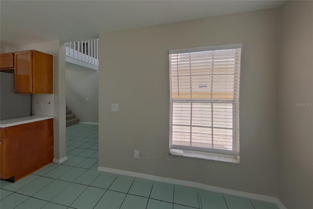 A room with light gray walls, a window with blinds, and light green floor tiles — 3257 BREWSTER DRIVE, KISSIMMEE, FL