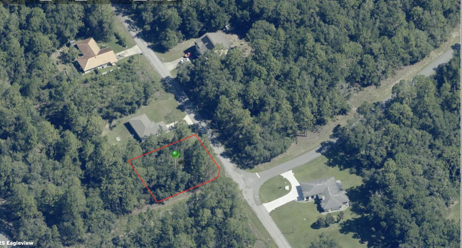 An aerial view shows a wooded, rectangular vacant lot outlined in red next to a road — 9524 N Sherman Drive, FL 34434, FL