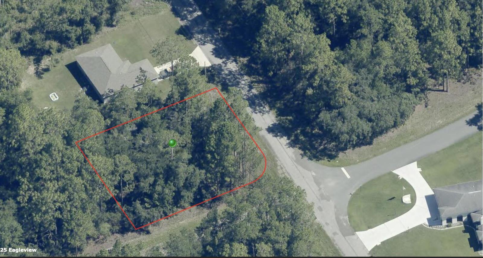 An aerial view shows a wooded, rectangular vacant lot outlined in red next to a road — 9524 N Sherman Drive, FL 34434, FL