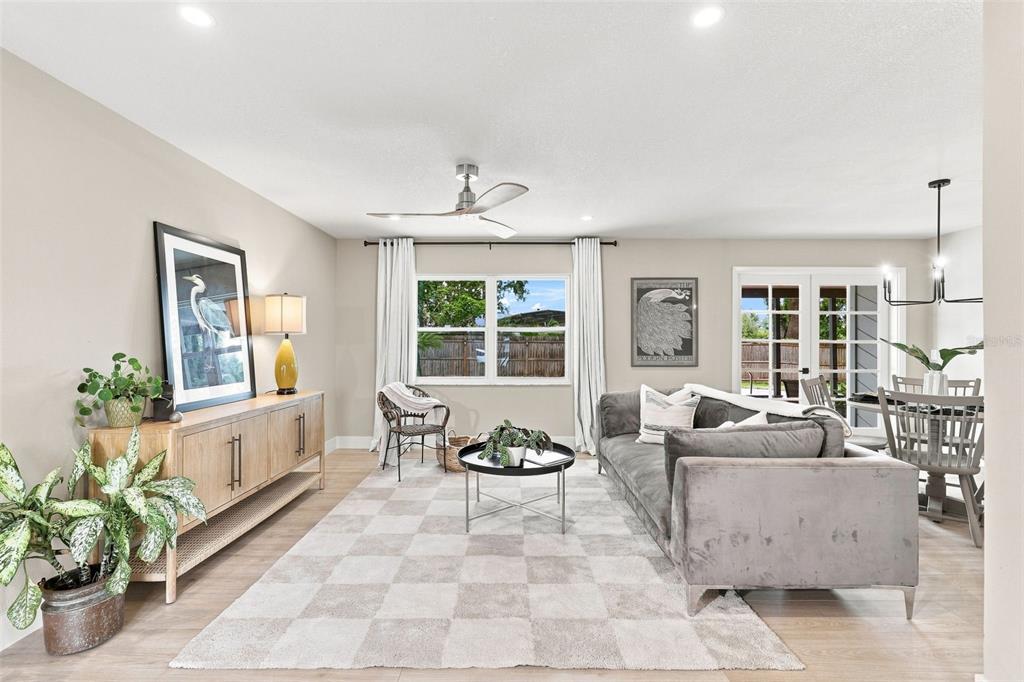 A living room features a gray sofa, a checkered rug, and a wooden sideboard — 1510 KENLYN DRIVE, LONGWOOD, FL