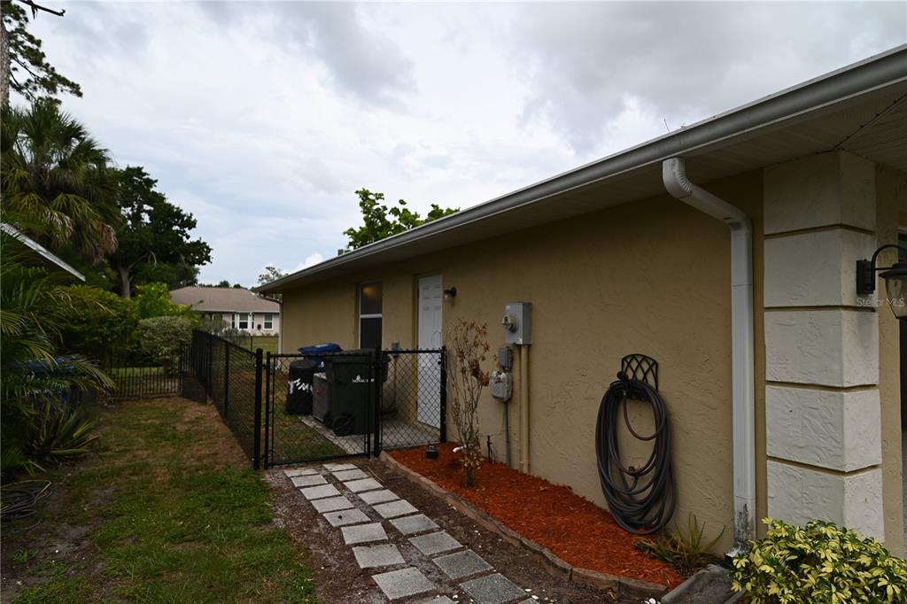 A living room with tile flooring, a ceiling fan, and sliding doors leading outside — 2043 OLD TRENTON LANE, SARASOTA, FL