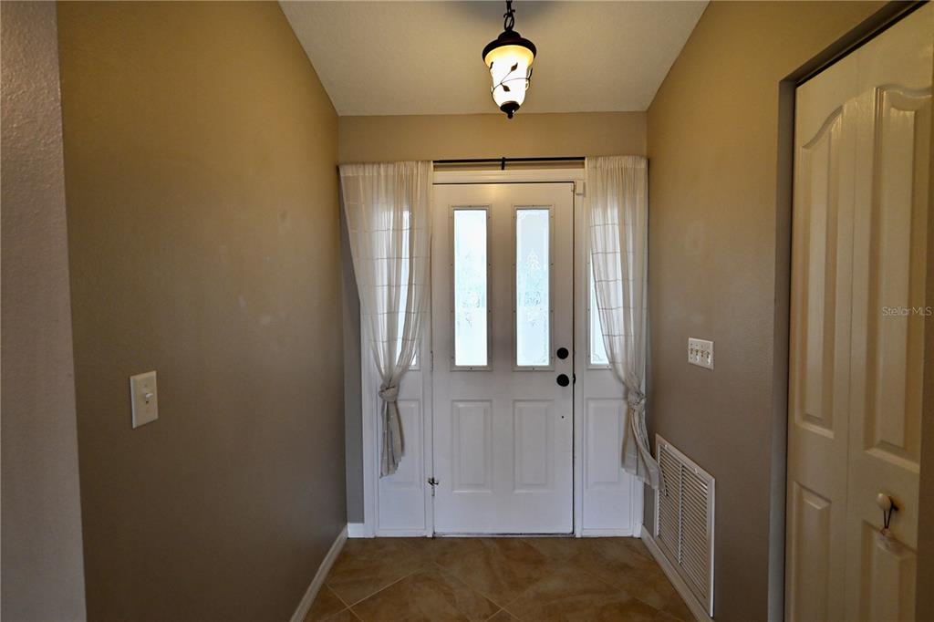 A kitchen with dark wood cabinets, granite countertops, stainless steel appliances, and a mosaic backsplash — 2043 OLD TRENTON LANE, SARASOTA, FL
