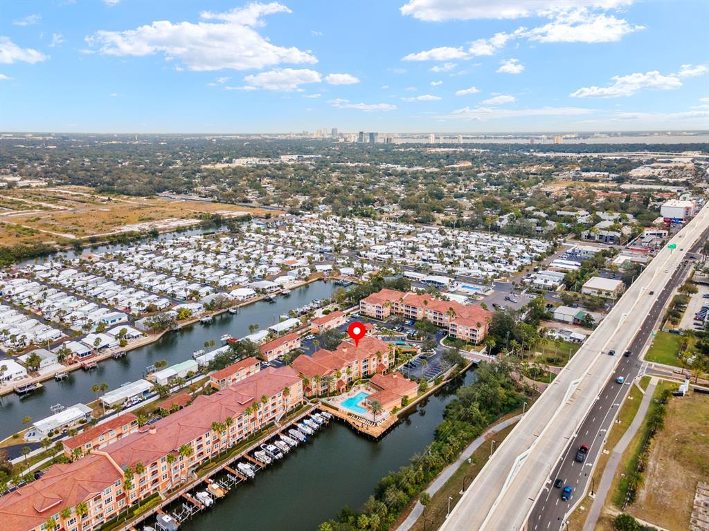 An aerial view shows a waterfront apartment complex with a pool and boat slips — 5000 CULBREATH KEY WAY UNIT 4303, TAMPA, FL