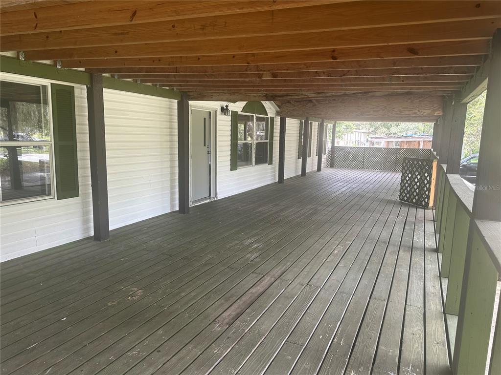 A concrete walkway leads to a circular driveway shaded by a large oak tree — 2363 GERBER DAIRY ROAD, WINTER HAVEN, FL