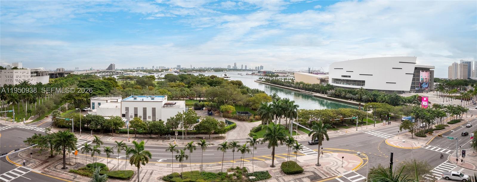 An elevated outdoor view shows a park, a waterway, and the Kaseya Center in Miami — 900 BISCAYNE BLVD # 909, Miami FL 33132, MIAMI, FL