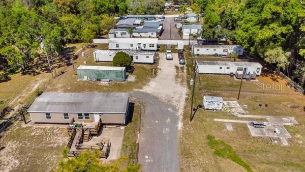 An aerial view shows a mobile home park with several trailers and a gravel driveway — 8325 EMMONS AVENUE, NEW PORT RICHEY, FL