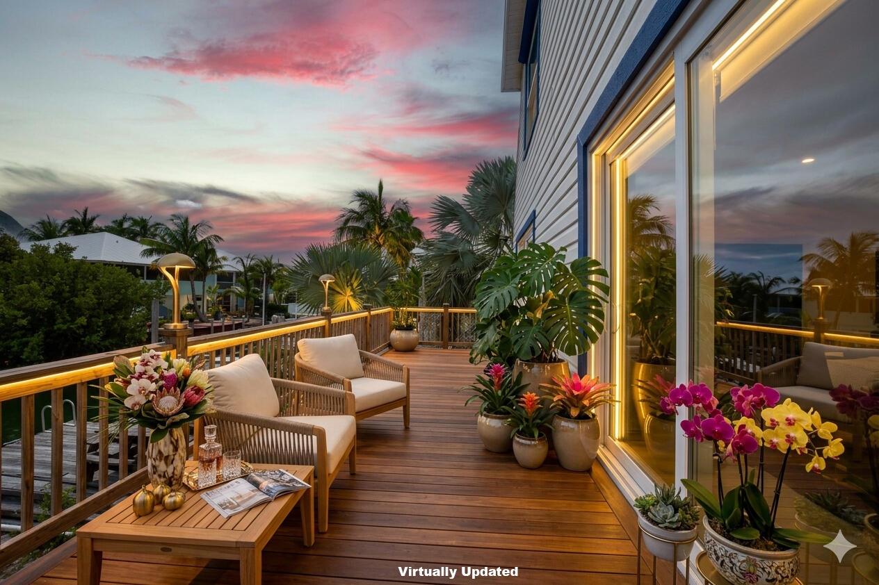 A wooden deck with outdoor seating, potted plants, and LED railing lights at sunset — 22920 Privateer Drive, FL 33042, FL