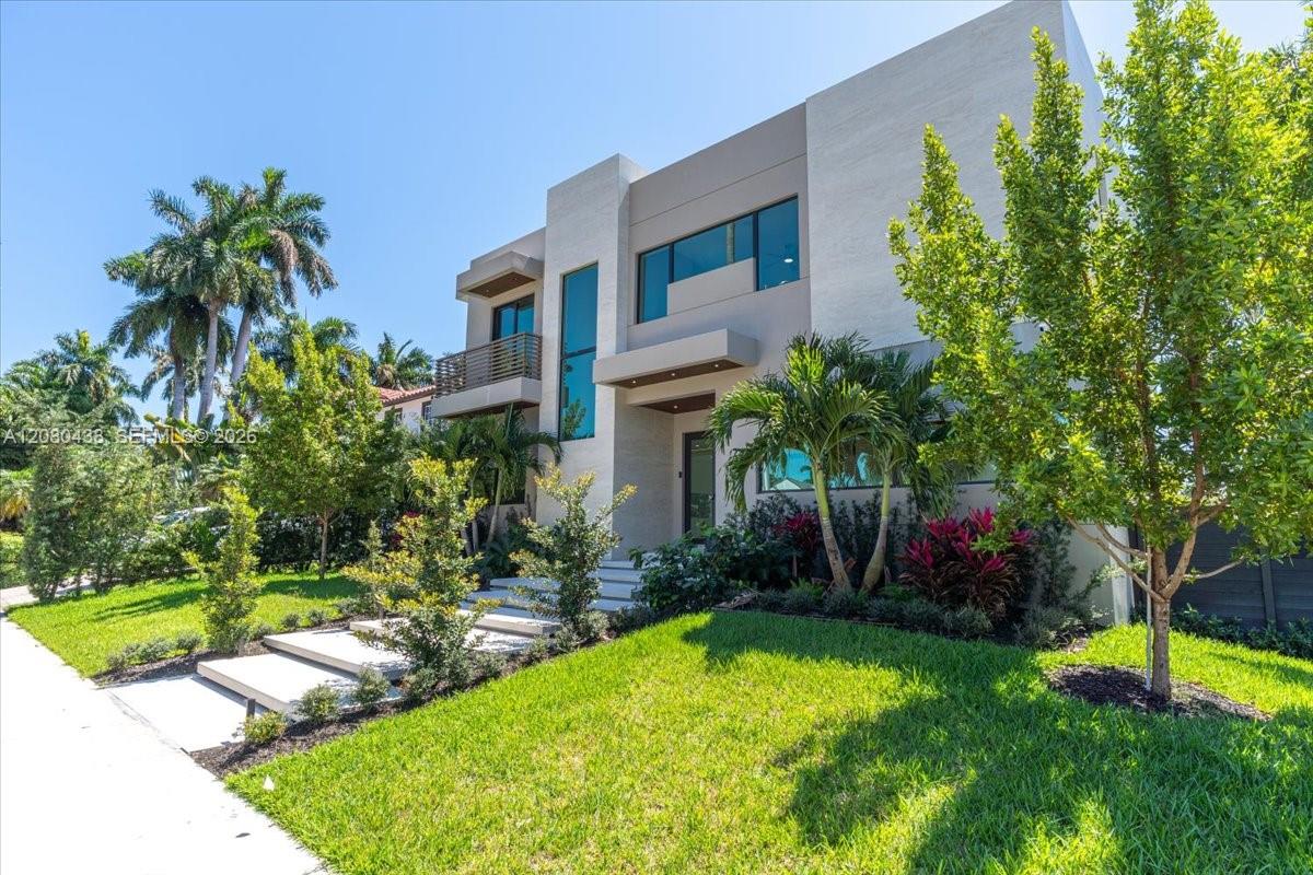 A modern two-story house features a light-colored facade, large windows, and a landscaped front yard — 1380 Hollywood Blvd, Hollywood FL 33019, HOLLYWOOD, FL