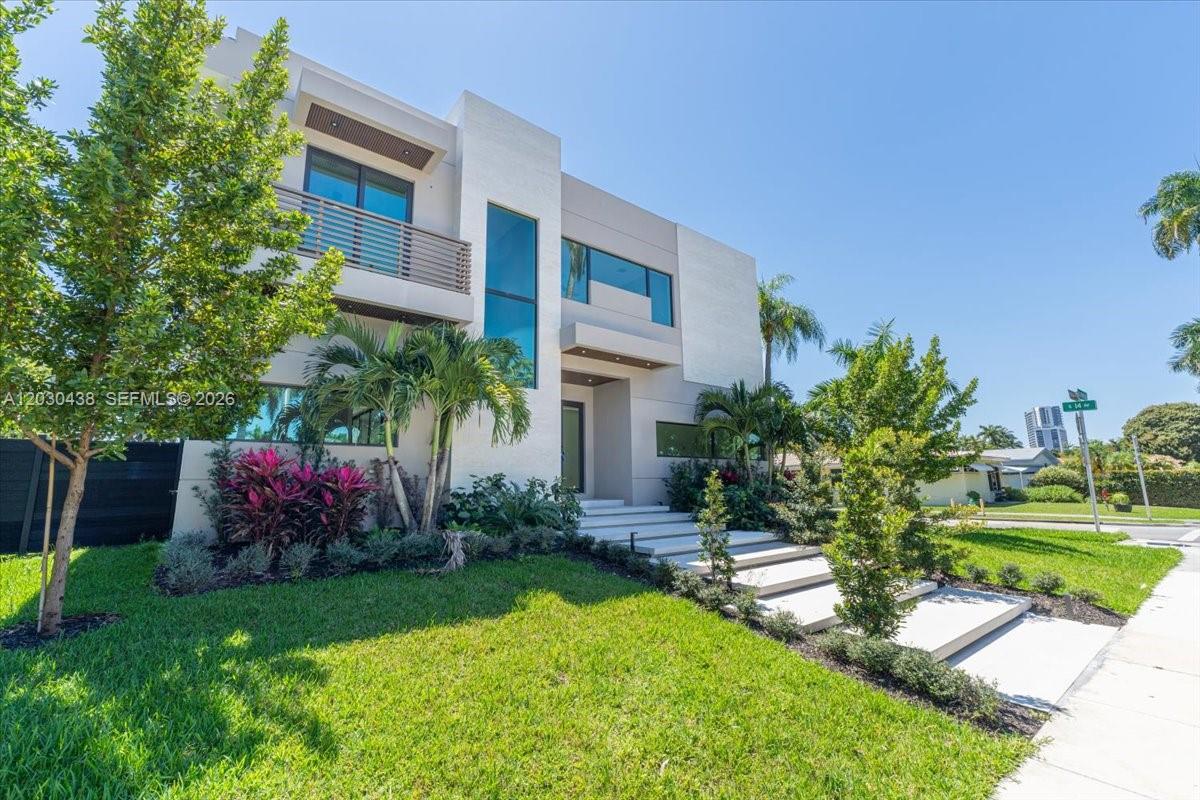 A modern two-story house features a flat roof, large windows, and concrete steps leading inside — 1380 Hollywood Blvd, Hollywood FL 33019, HOLLYWOOD, FL
