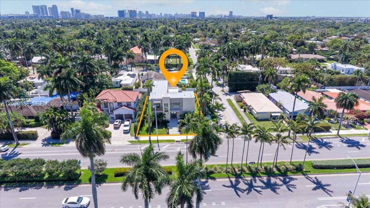 An aerial view shows a modern two-story house surrounded by palm trees and residential streets — 1380 Hollywood Blvd, Hollywood FL 33019, HOLLYWOOD, FL
