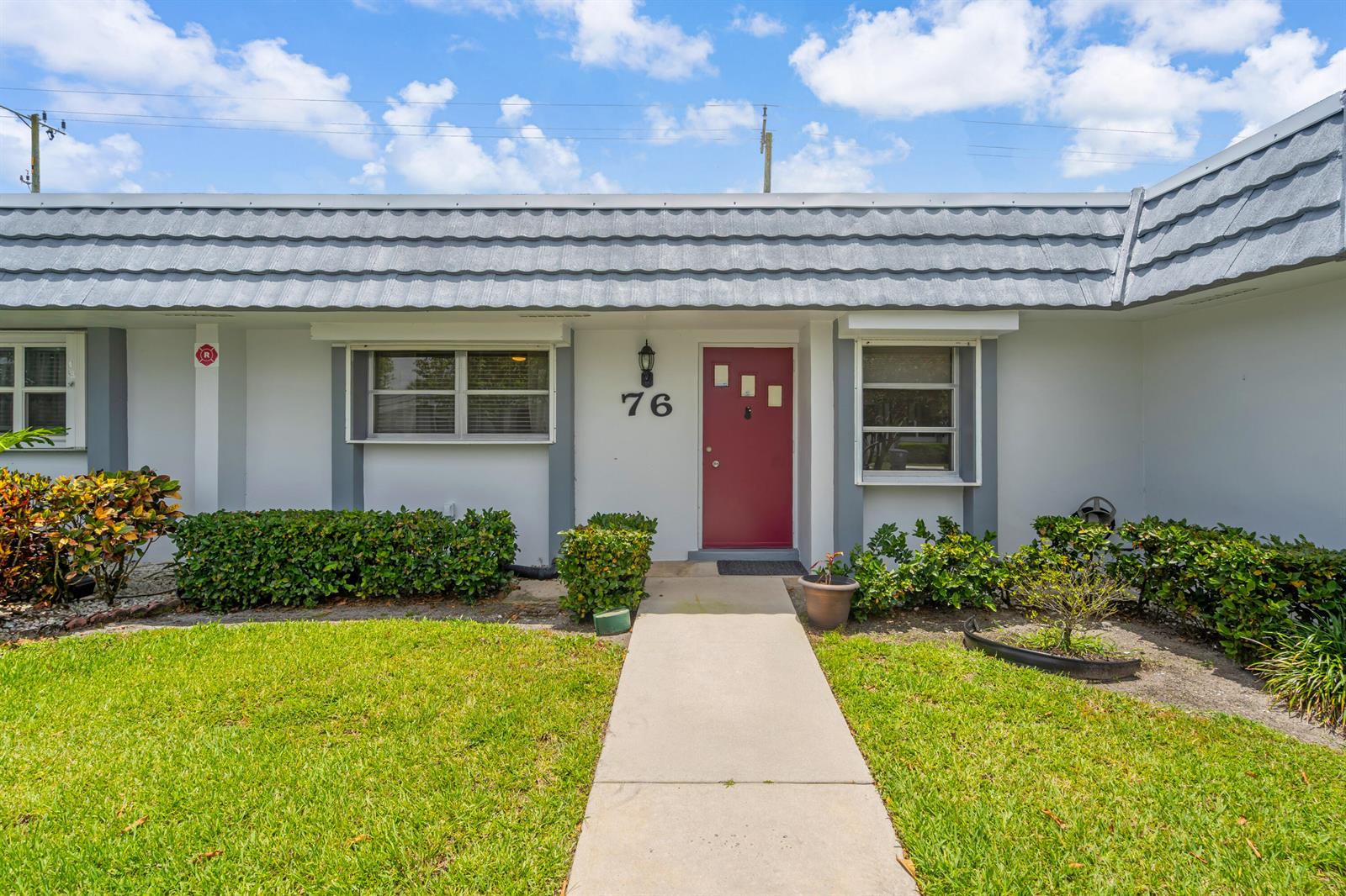 A single-story residence features a red front door, gray roof tiles, and a concrete walkway — 2886 Fernley Drive E # 76, West Palm Beach FL 33415, WEST PALM BEACH, FL