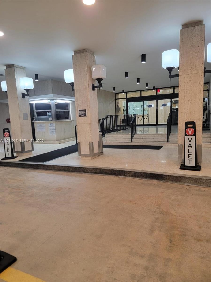 A valet drop-off area features stone pillars, glass doors, and a small security booth — 500 Three Islands Blvd # 709, Hallandale Beach FL 33009, HALLANDALE BEACH, FL