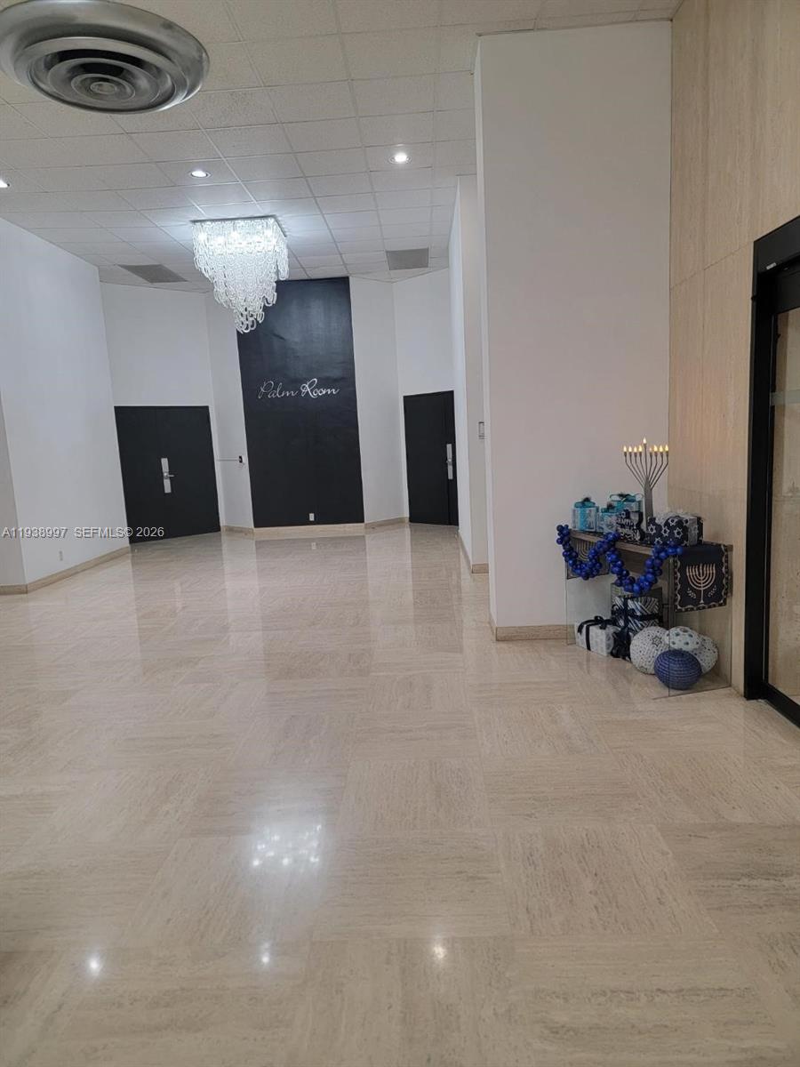 A lobby features a chandelier, a black accent wall labeled Palm Room, and Hanukkah decorations — 500 Three Islands Blvd # 709, Hallandale Beach FL 33009, HALLANDALE BEACH, FL