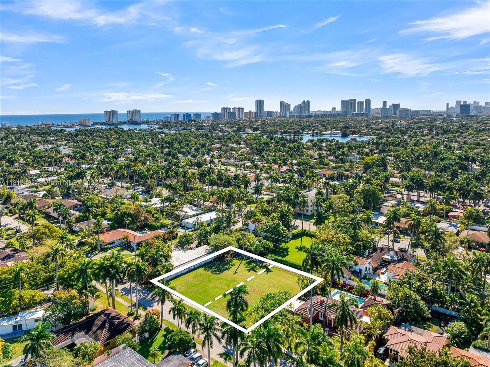 An aerial view shows a vacant, rectangular residential lot outlined in white amidst a suburban neighborhood — 1310 Polk St, Hollywood FL 33019, HOLLYWOOD, FL