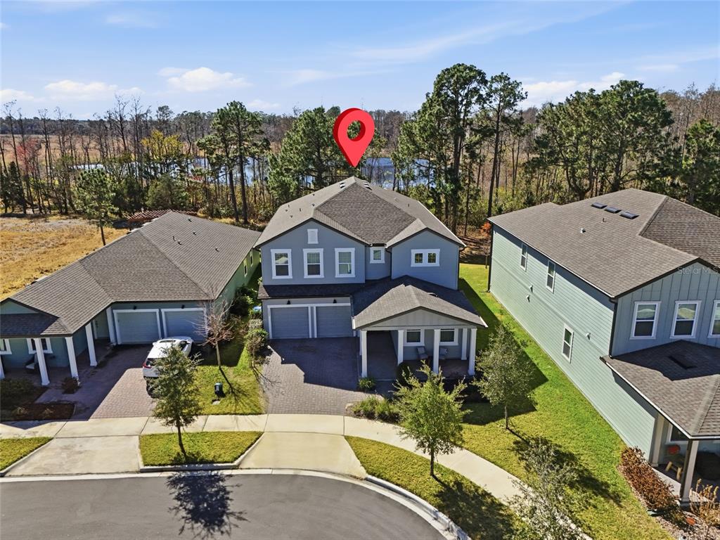An aerial view of a two-story suburban house with a gray exterior and attached garage — 17222 DANCY ORANGE COURT, WINTER GARDEN, FL