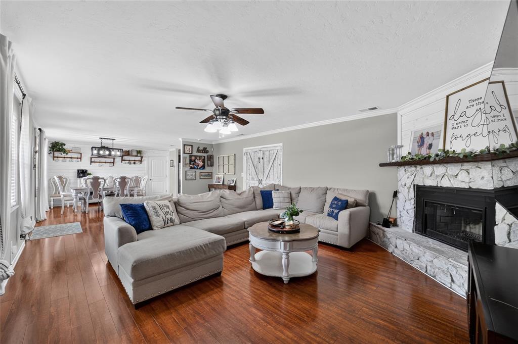 A living room features a large sectional sofa, a stone fireplace, and hardwood floors — 1861 SE 56TH COURT, OCALA, FL