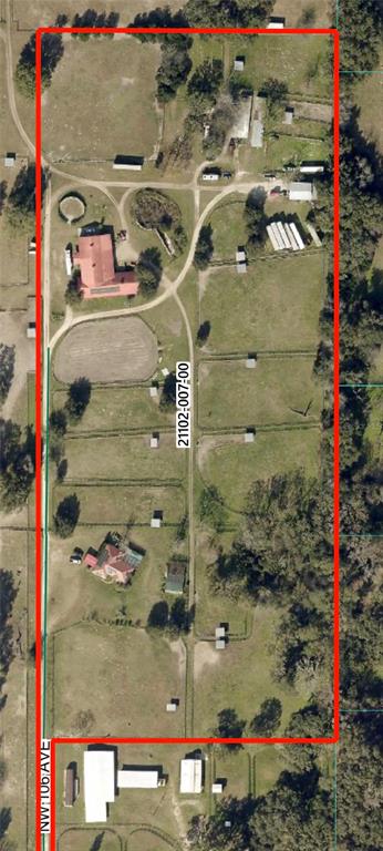 This is an aerial map showing a rural property with multiple buildings, pastures, and paddocks — 311 NW 106TH AVENUE, OCALA, FL