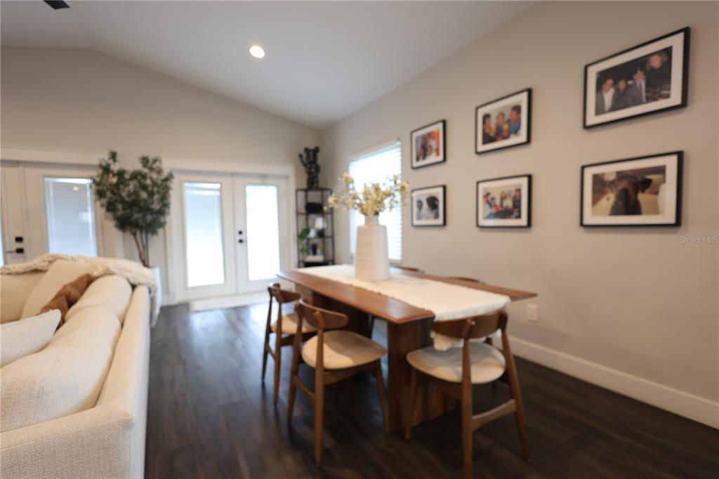 A modern kitchen features light wood cabinets, a large white island, and four brown barstools — 655 12TH AVENUE S, ST PETERSBURG, FL