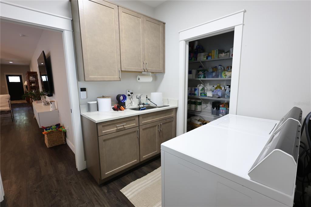 A kitchen with light wood cabinets, stainless steel appliances, white countertops, and a tile backsplash — 655 12TH AVENUE S, ST PETERSBURG, FL