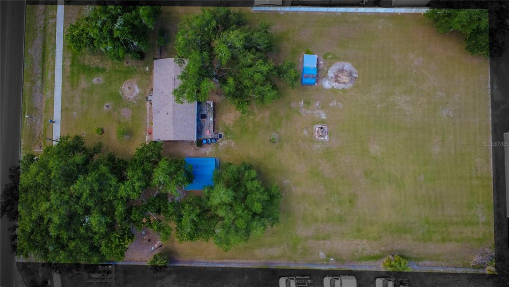 An aerial view shows a house with a large yard, several trees, and outbuildings — 5015 TURKEY CREEK ROAD, PLANT CITY, FL