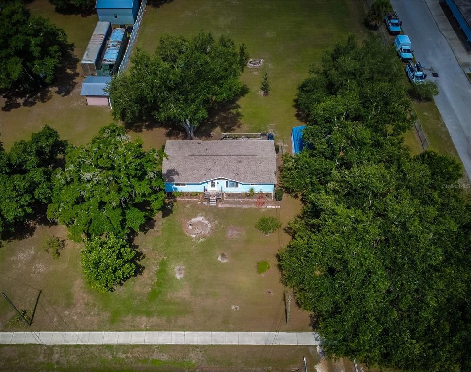 An aerial view shows a light blue house surrounded by trees and a large yard — 5015 TURKEY CREEK ROAD, PLANT CITY, FL