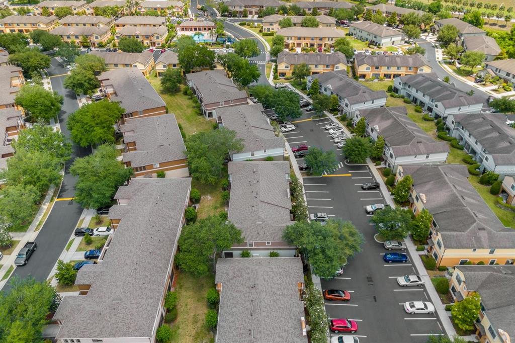 An aerial view shows multiple multi-story residential buildings surrounded by parking lots and green spaces — 3360 WINDLESHORE WAY, SANFORD, FL