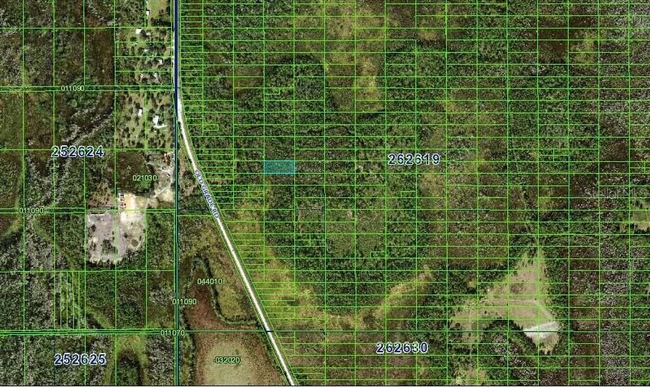 This is a satellite map view showing a highlighted land parcel along a road — N/A, POLK CITY, FL