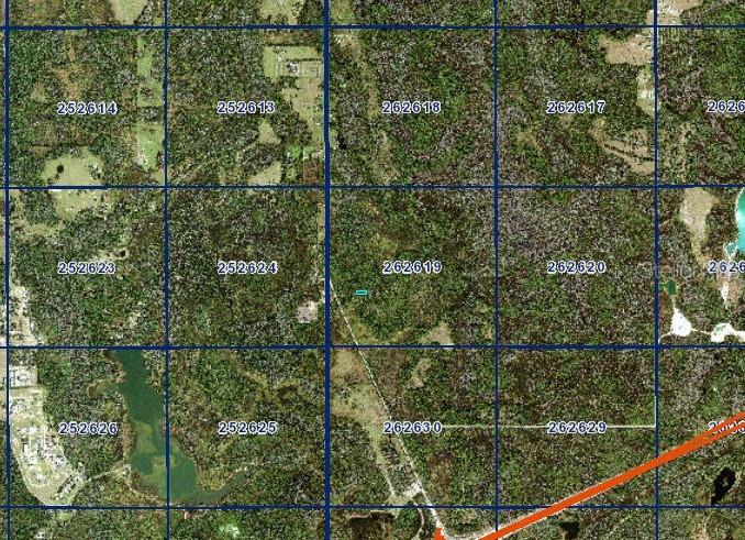 This is a satellite map showing numbered land parcels divided by a grid — N/A, POLK CITY, FL