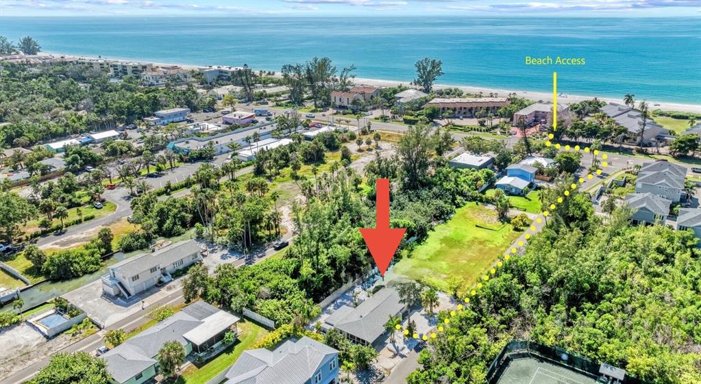 An aerial view shows a house with a red arrow pointing to it near beach access — 578 COMPANION WAY, LONGBOAT KEY, FL