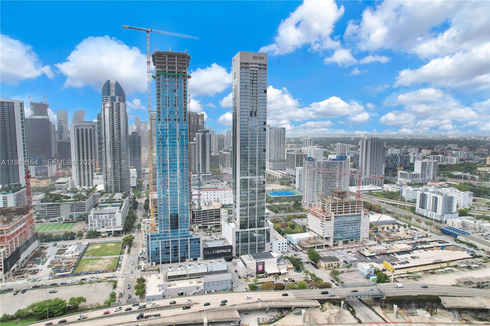 An aerial view shows high-rise buildings under construction in a dense urban city landscape — 20 NE 11th St # 4803A, Miami FL 33132, MIAMI, FL