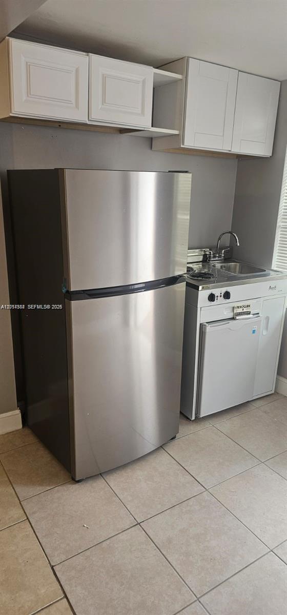 A small kitchen area features a stainless steel refrigerator next to a compact kitchenette unit — 6951 SW 26th St # w, Miramar FL 33023, MIRAMAR, FL