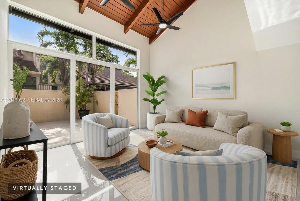 A virtually staged living room features a vaulted wood ceiling, large windows, and modern furniture — 11621 SW 90th St, Miami FL 33176, MIAMI, FL