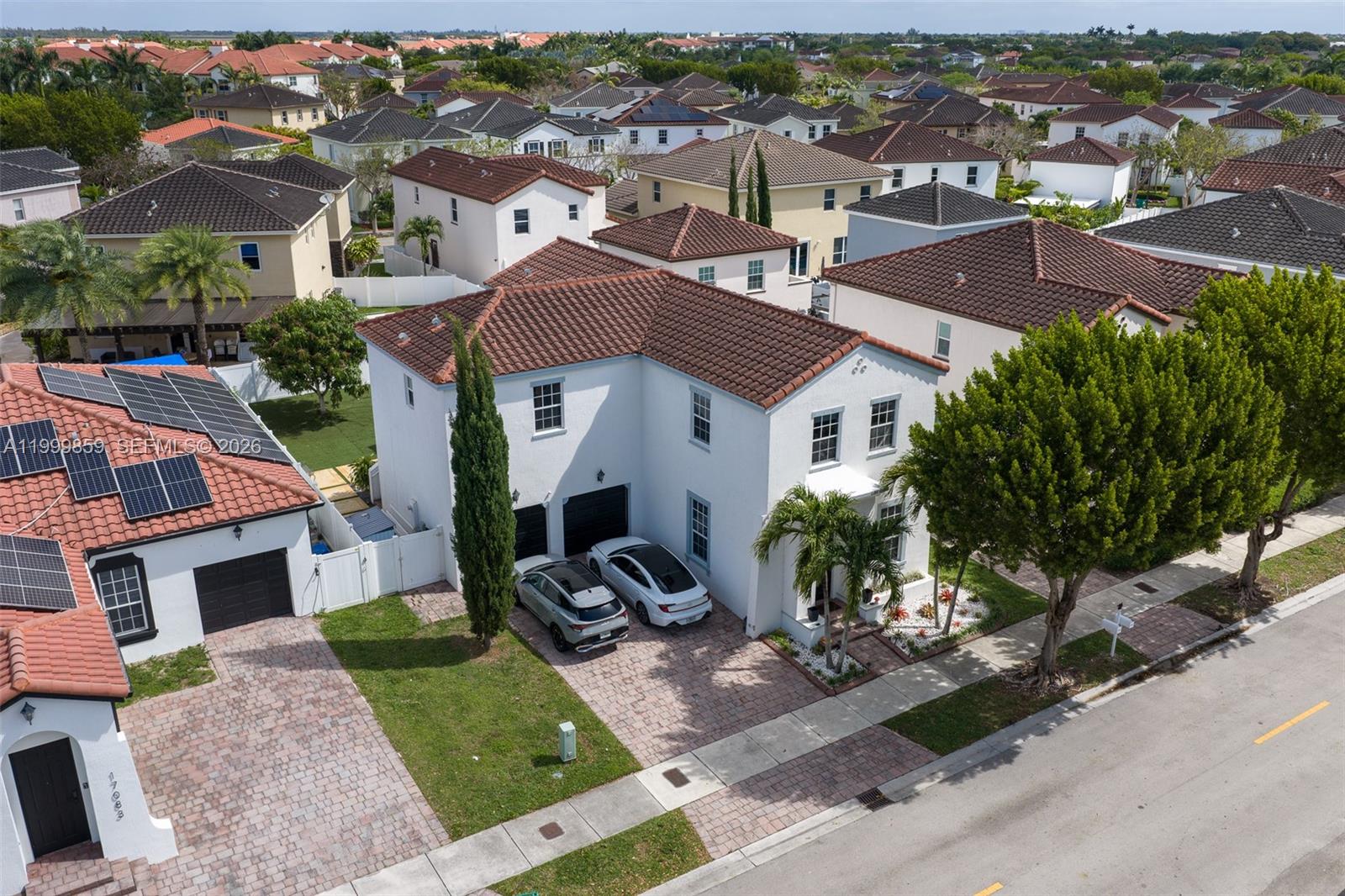 An aerial view shows a two-story white house with a brown tile roof and driveway — 17081 SW 94th Way, Miami FL 33196, MIAMI, FL