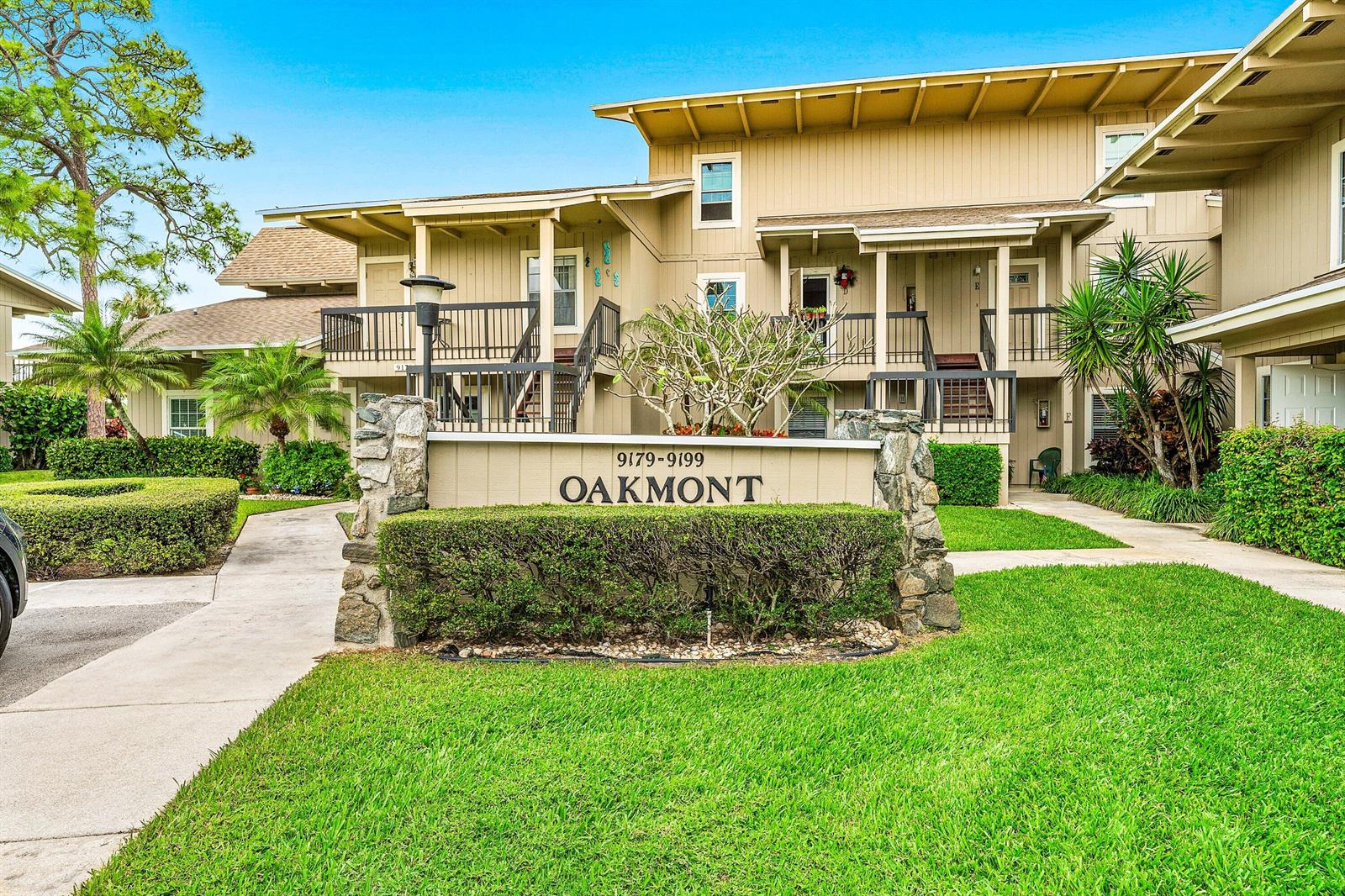 A two-story apartment building features a stone-based sign for Oakmont in the foreground — 9179 SE Riverfront Terrace # F, Jupiter FL 33469, JUPITER, FL