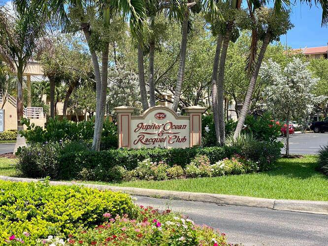 A sign for the Jupiter Ocean and Racquet Club stands in a landscaped garden area — 1605 S Us Highway 1 # B105, Jupiter FL 33477, JUPITER, FL