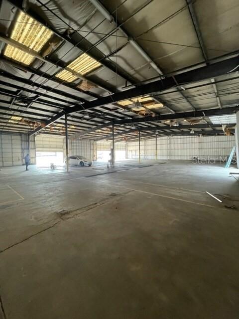 A large, open industrial warehouse space features a concrete floor and exposed metal ceiling beams — 2525 CLARCONA ROAD, APOPKA, FL