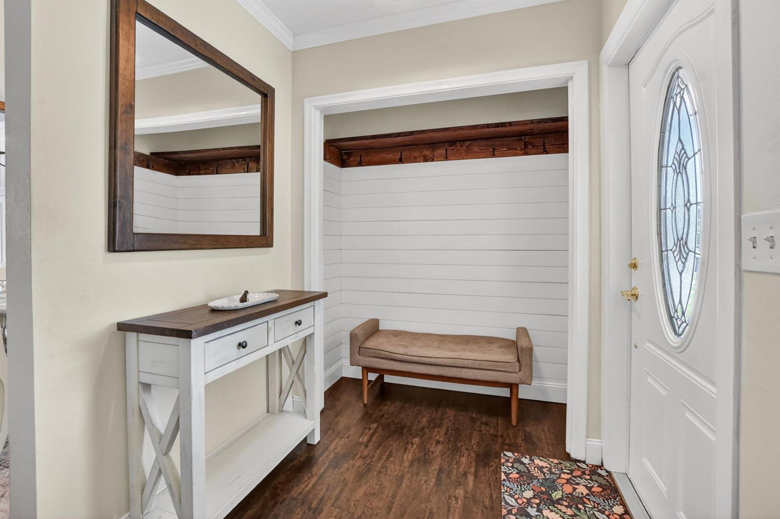 An entryway features a white console table, a wall mirror, and a bench in a nook — 1207 SW 12th Avenue, Boca Raton FL 33486, BOCA RATON, FL