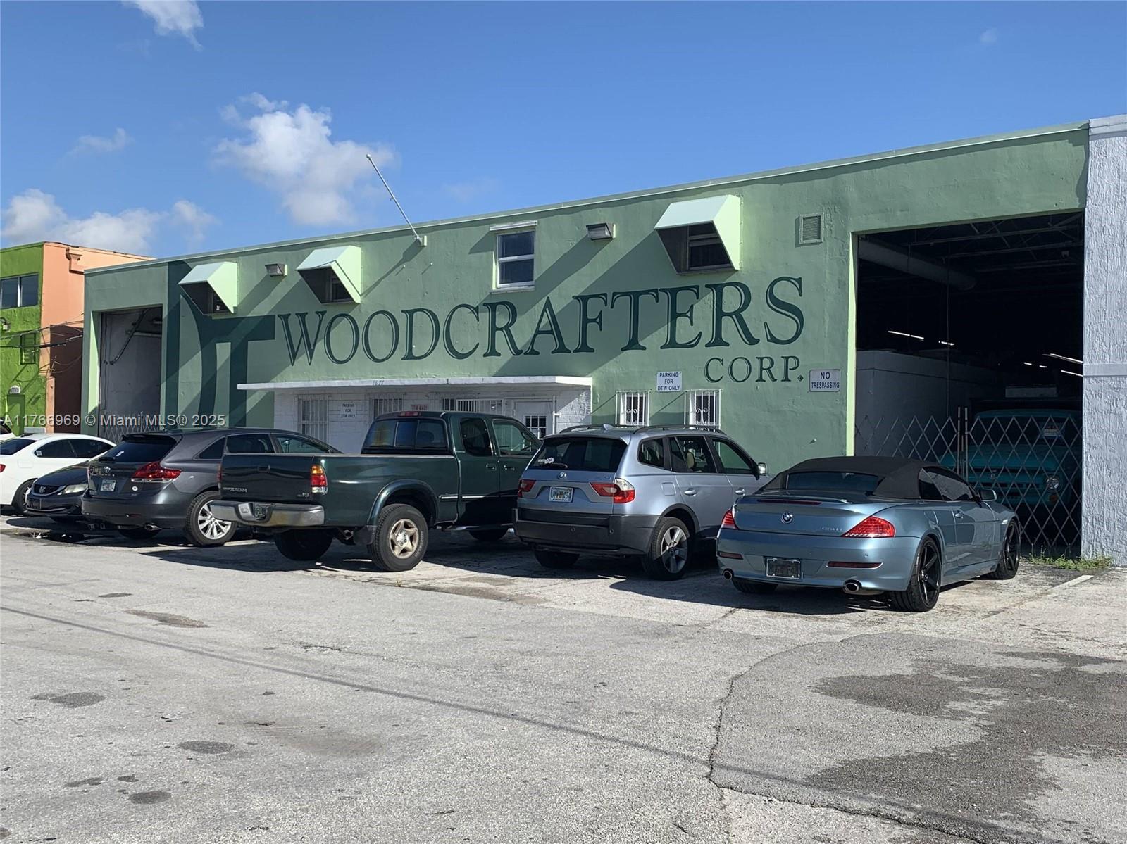 A light green industrial building with a large sign and several parked cars in front — 1677 W 31st Pl # 1677, Hialeah FL 33012, HIALEAH, FL