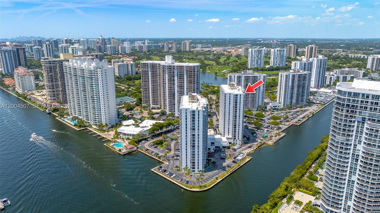 An aerial view shows multiple high-rise residential buildings situated along a waterway — 20505 E Country Club Dr # 38, Aventura FL 33180, AVENTURA, FL