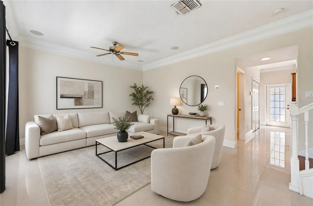 A bright living room features a white sectional sofa, two armchairs, and a coffee table — 6390 SOUTHBRIDGE STREET, WINDERMERE, FL