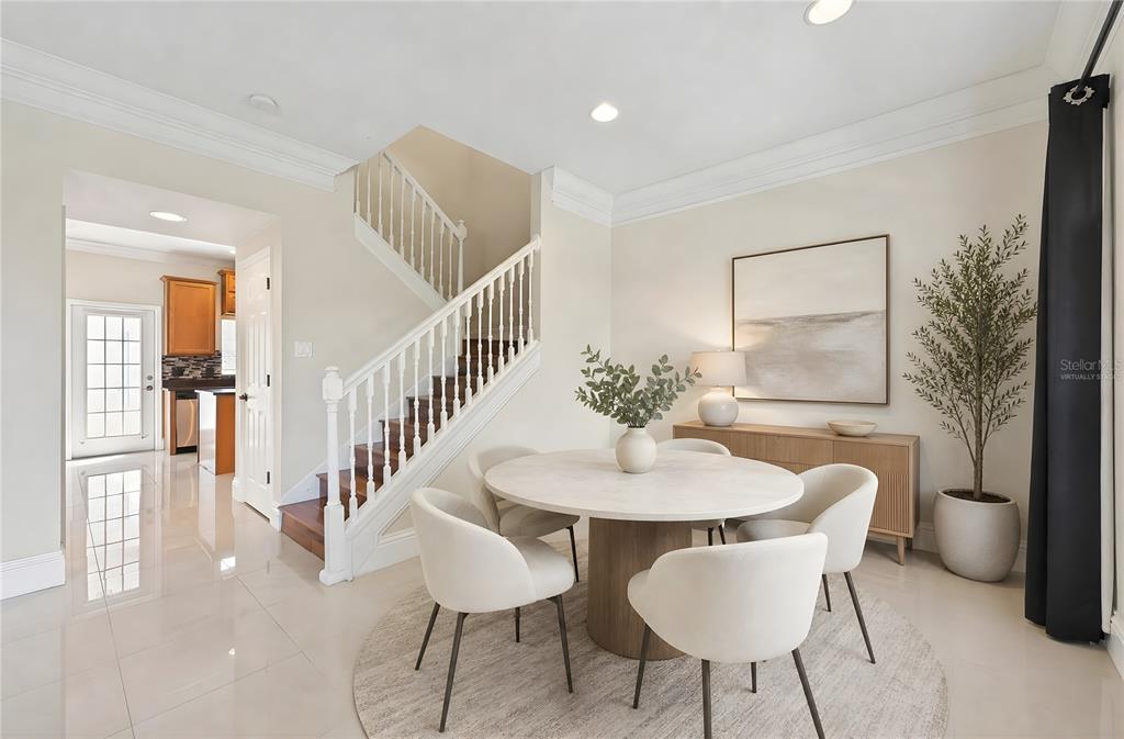 A dining area features a round table, four chairs, a staircase, and light tile flooring — 6390 SOUTHBRIDGE STREET, WINDERMERE, FL