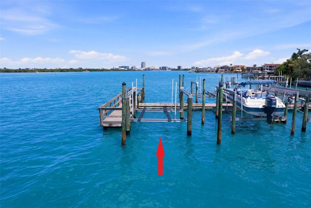 A three-story peach-colored townhouse with a tile roof and a gravel driveway — 200 BRIGHTWATER DRIVE UNIT 10, CLEARWATER BEACH, FL